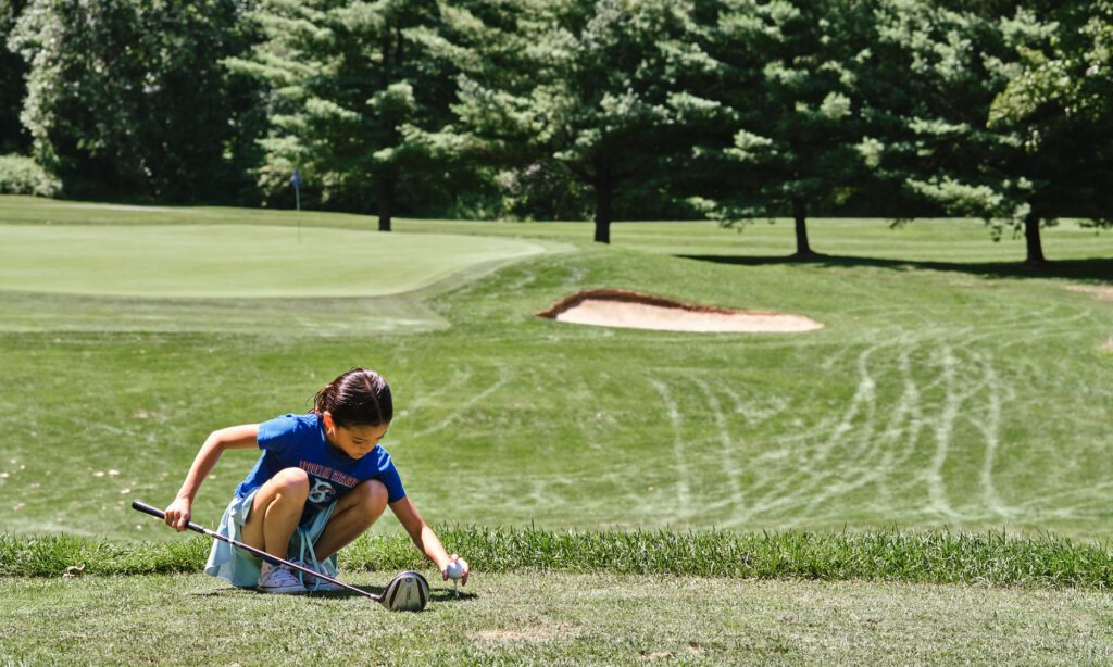 young golfer preparing to tee